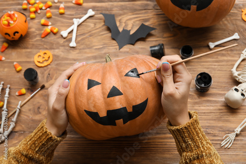 Woman painting Halloween pu...