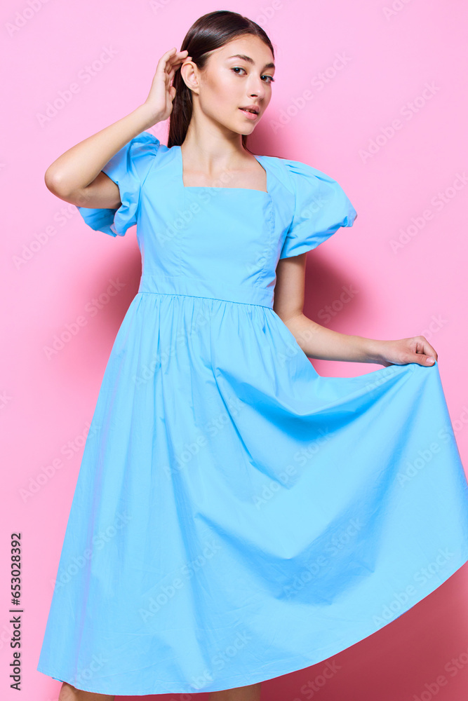 Fototapeta premium happy woman fashion studio young dress beautiful blue model pink style