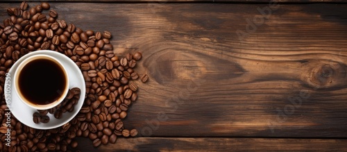 Coffee beans and cup on wood background