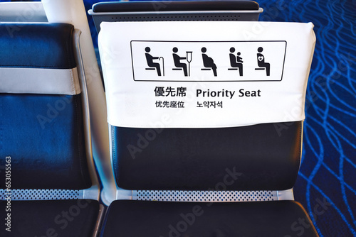 Selective focus of priority seat sign in multi language.