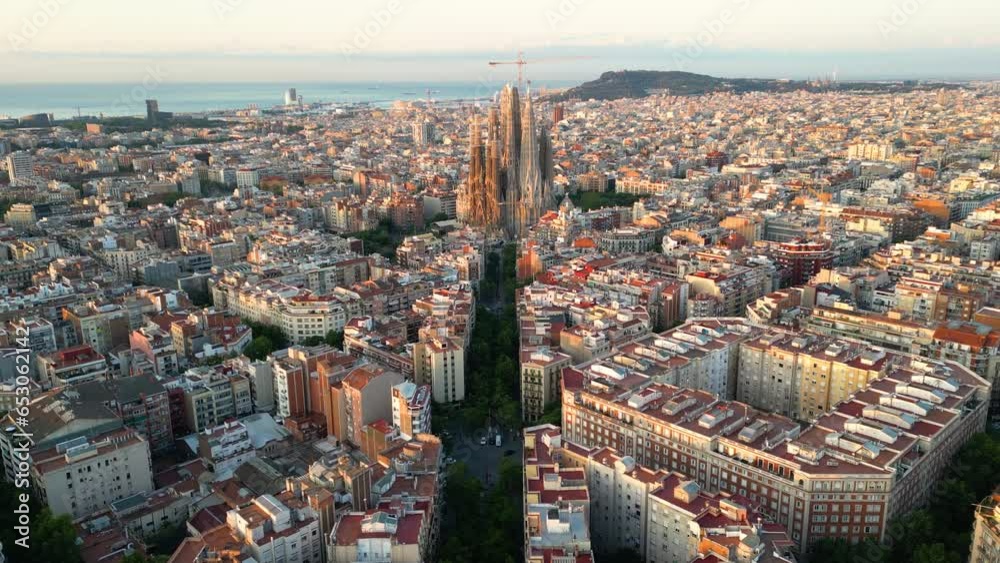 Establishing aerial view shot Barcelona Eixample residential district and famous Basilica Sagrada Familia at sunrise. Catalonia, Spain