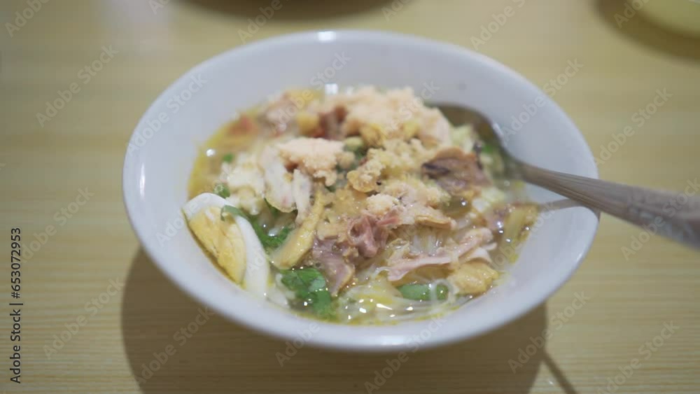 A bowl of Soto Koya Lamongan, Indonesian food curry with chicken meat and vegetables originally from East Java A bowl of Soto Koya Lamongan, Indonesian food curry with chicken meat and vegetables originally from East Java