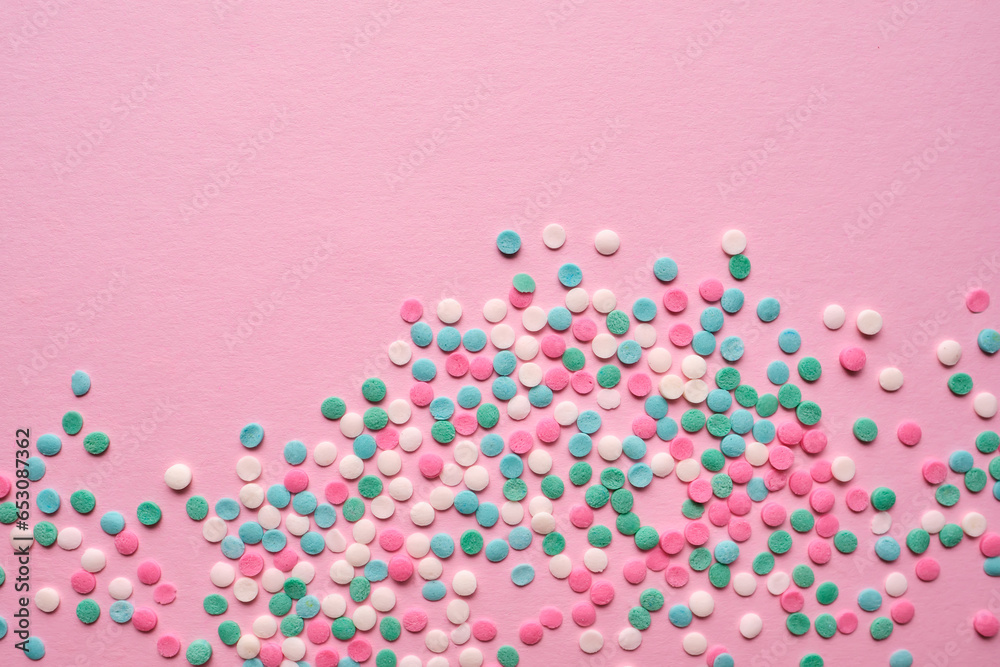 Multi-colored confectionery topping on a pink. Multi-colored confectionery topping on a pink.