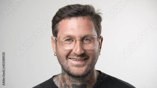 Handsome person look at camera close up. Young adult man face portrait. Stylish 30s guy on isolated white background. Attractive male model. Modern millennial people. Brutal bearded style. Barber shop