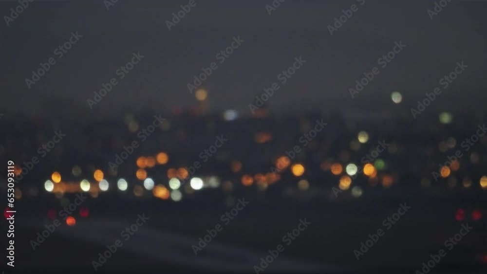 Blurry city lights in the night. Colorful bokeh with city lights in the background. Selective focus, night life, atmospheric mood. Cluj city lights.