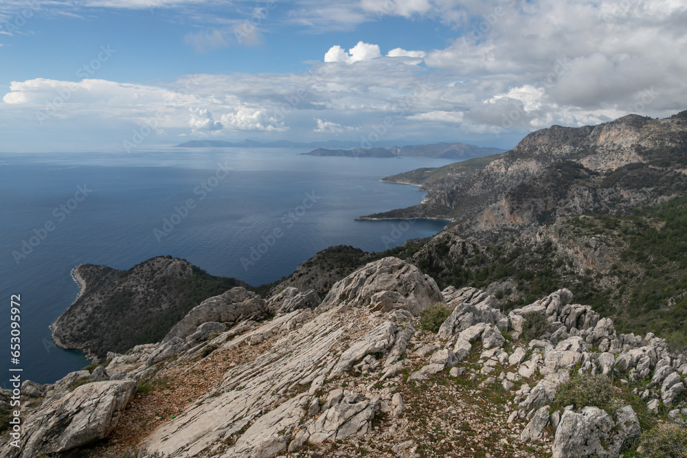 A coastal landscape of Mediterranean sea at Kalabantia. Amazing seascape of Lycian way: high rock cliffs, mountain ridge, rugged shoreline, blue lagoon. Fascinating hiking journey of south Turkey. 