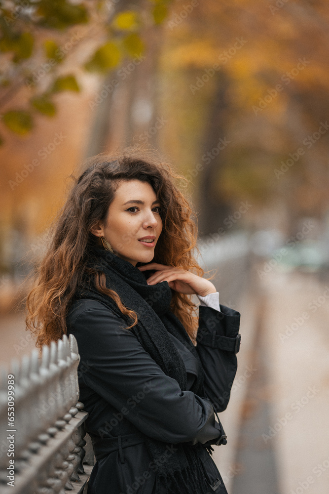 Portrait of a beautiful curly girl in the park in autumn Portrait of a beautiful curly girl in the park in autumn
