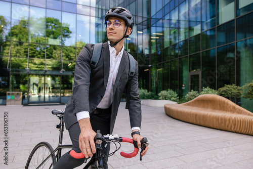 Businessman riding an electric scooter and looking contented photo