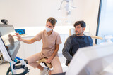 Dentist showing 3d image to patient sitting on a chair