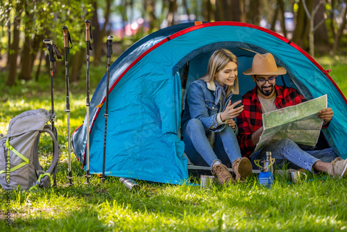Young couple of travelers in the tent feeling relaxed