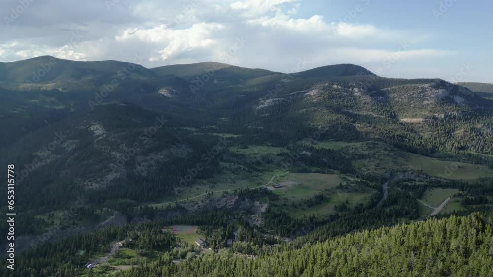 Shaded Mountain Range Looms Over Summer Campground in Pine Tree Forest Shaded Mountain Range Looms Over Summer Campground in Pine Tree Forest