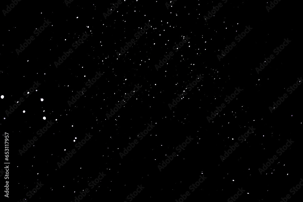 Snow on a black background. Snowflakes in the form of stars. Snowfall.