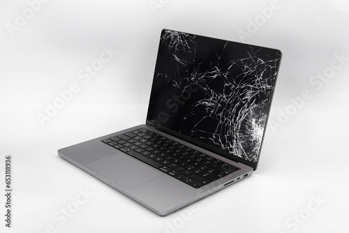 Broken LCD display on laptop computer. Isolated white background.