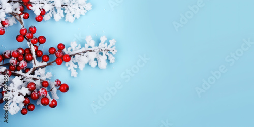 Christmas or winter composition. Snowflakes and red berries on blue background, copy space