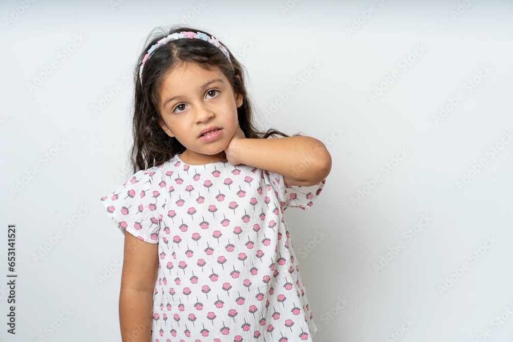 beautiful kid girl wearing dress Suffering of neck ache injury, touching neck with hand, muscular pain beautiful kid girl wearing dress Suffering of neck ache injury, touching neck with hand, muscular pain