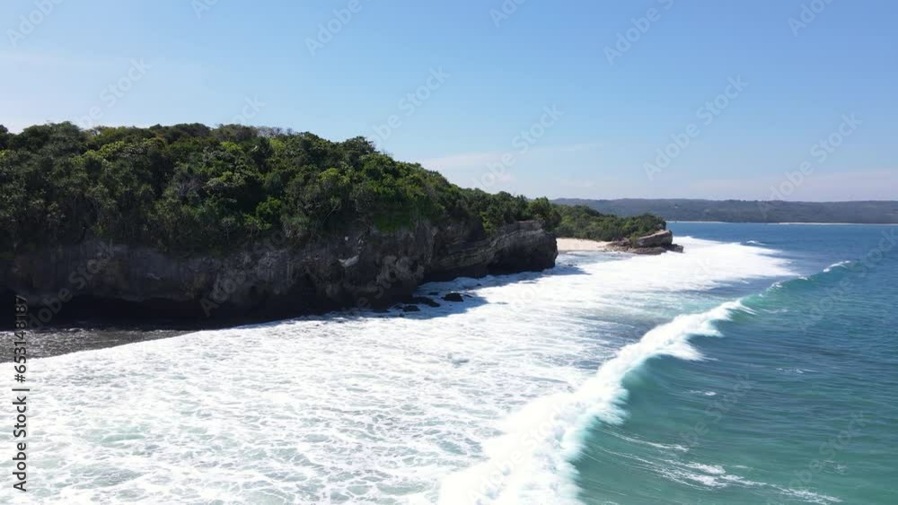 Waves Rolling Into Foamy Surface At Pantai Watu Bella In West Sumba Regency, East Nusa Tenggara, Indonesia. Aerial Shot Waves Rolling Into Foamy Surface At Pantai Watu Bella In West Sumba Regency, East Nusa Tenggara, Indonesia. Aerial Shot
