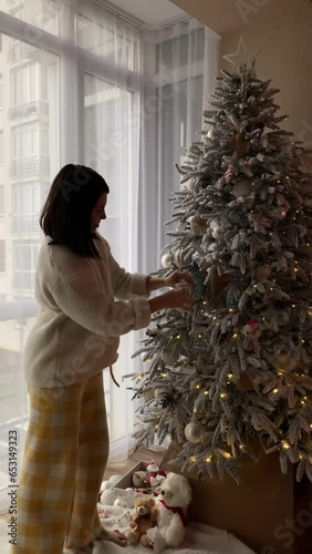 happy woman decoration christmas tree