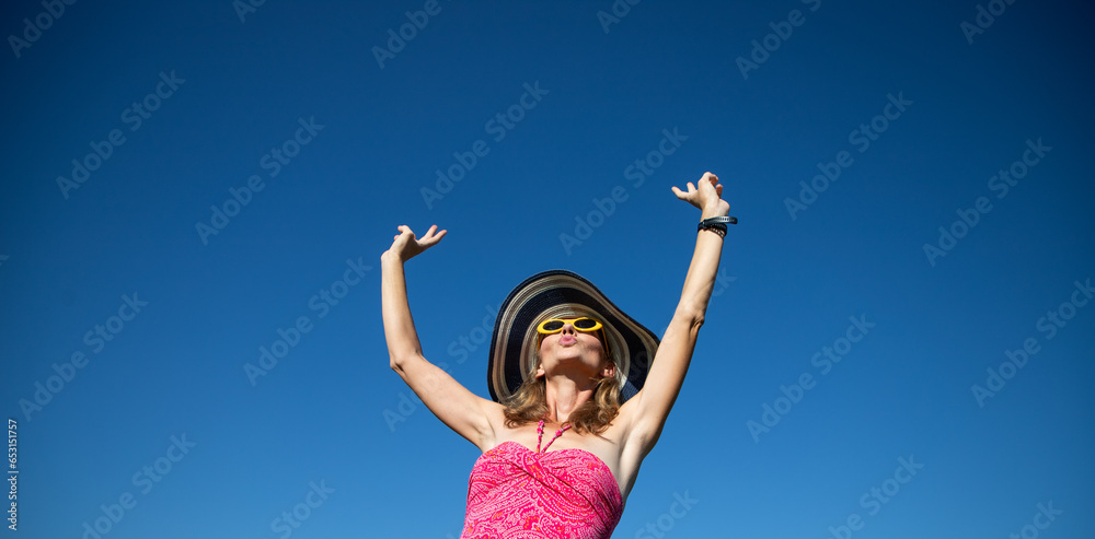 happy woman in pink swimsuit against blue sky holiday concept