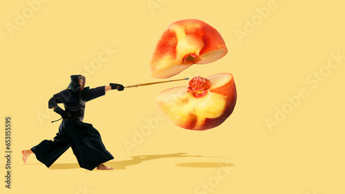 Fotografie Active young man, kendo athlete cutting peach over yellow background