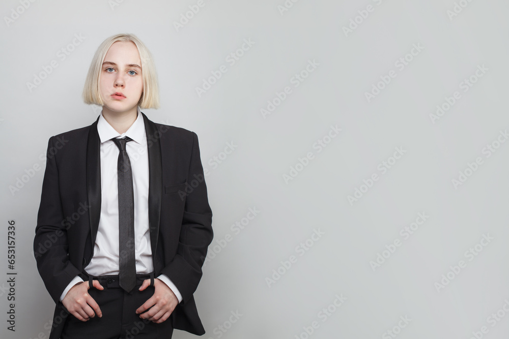 Gorgeous woman with blonde bob hairstyle posing in black suit and tie Gorgeous woman with blonde bob hairstyle posing in black suit and tie