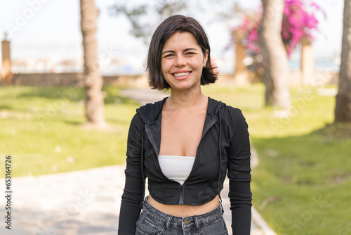 Young pretty Bulgarian woman at outdoors With happy expression