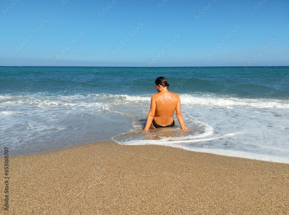 girl swimming among the waves in Cabo de Gata Almería girl swimming among the waves in Cabo de Gata Almería