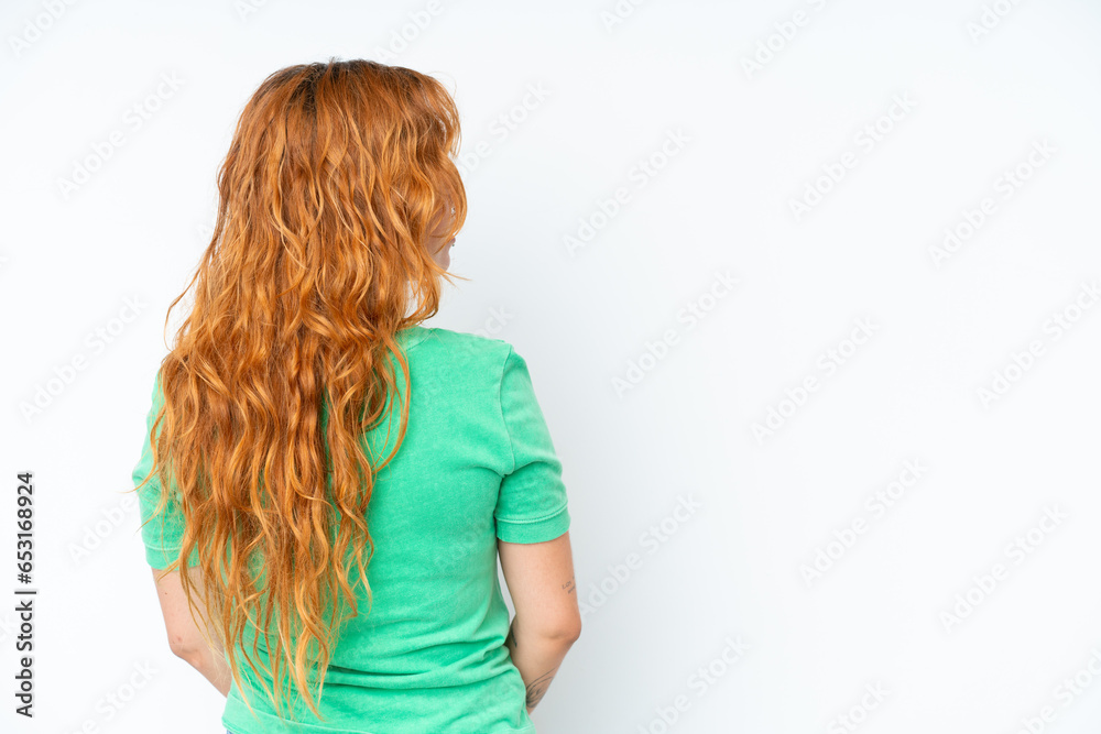 Young caucasian woman isolated on white background in back position and looking side Young caucasian woman isolated on white background in back position and looking side