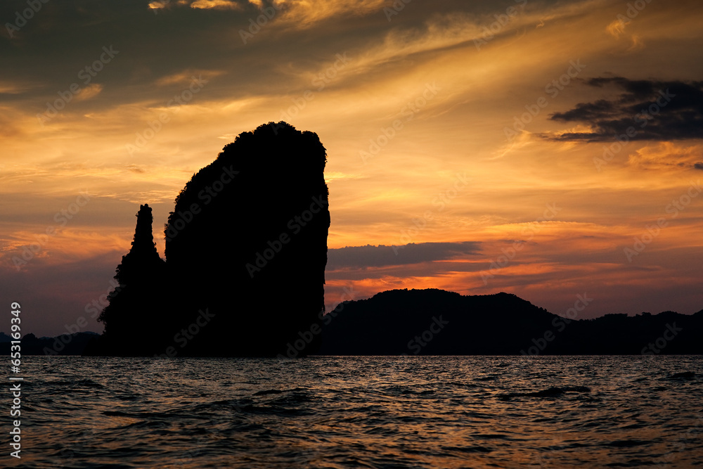 A silhouette of an Island in Thailand as the sun sets. 
