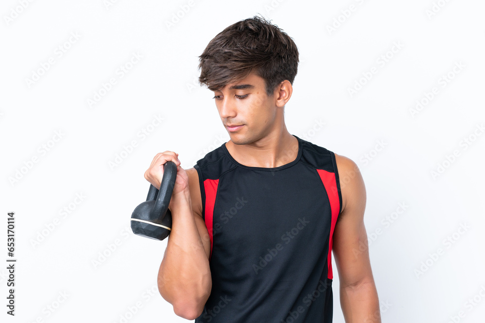 Young caucasian man isolated on white background making weightlifting with kettlebell Young caucasian man isolated on white background making weightlifting with kettlebell