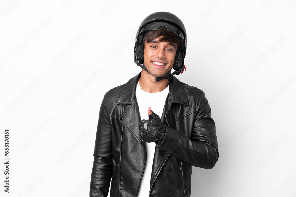 Young man with a motorcycle helmet isolated on white background giving a thumbs up gesture Young man with a motorcycle helmet isolated on white background giving a thumbs up gesture