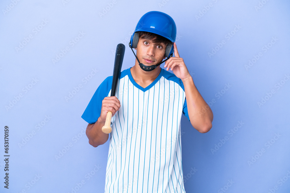 Baseball caucasian man player with helmet and bat isolated on blue background thinking an idea