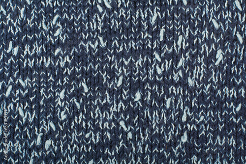 Sweater or scarf fabric texture large knitting. Knitted jersey background with a relief pattern. Wool hand- machine, handmade.