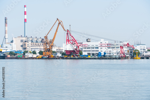 View of industrial plant and smoke stacks  Container ship on river harbor  Shanghai  China