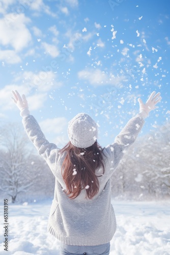 Beautiful asian woman enjoy snowfall in the park. Lifestyle concept.
