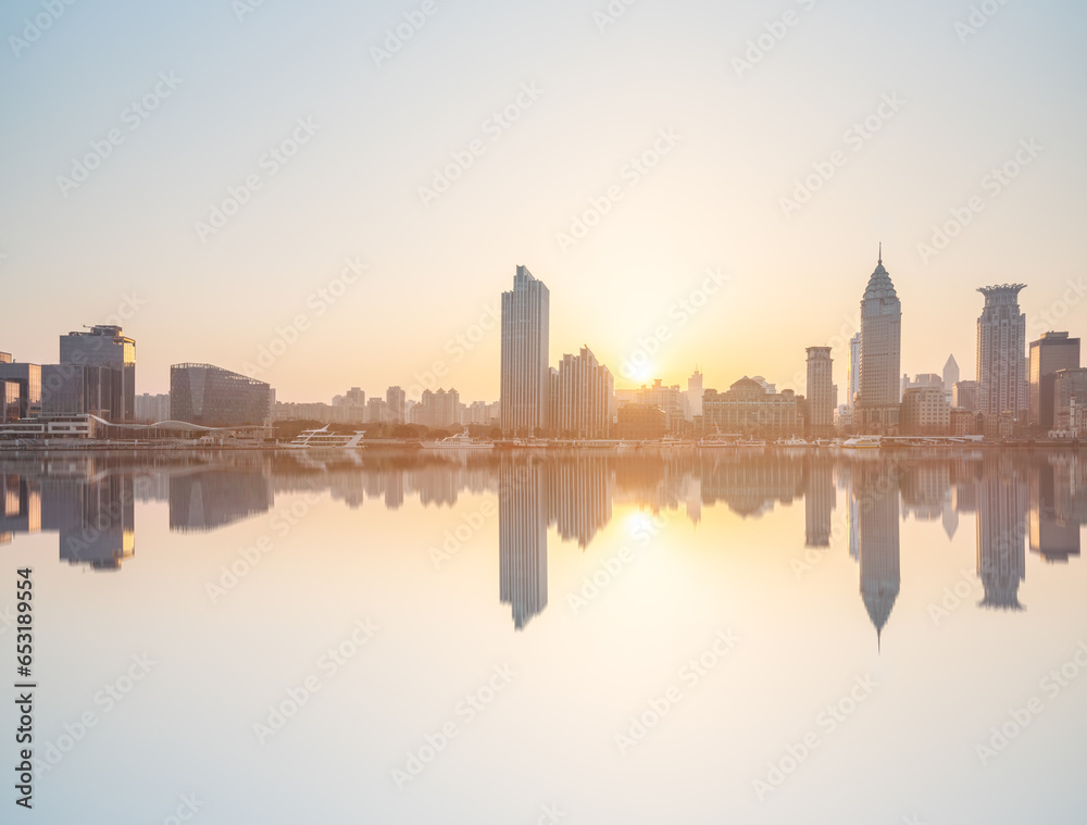 skyline of Shanghai financial district buildings by river at sunset skyline of Shanghai financial district buildings by river at sunset