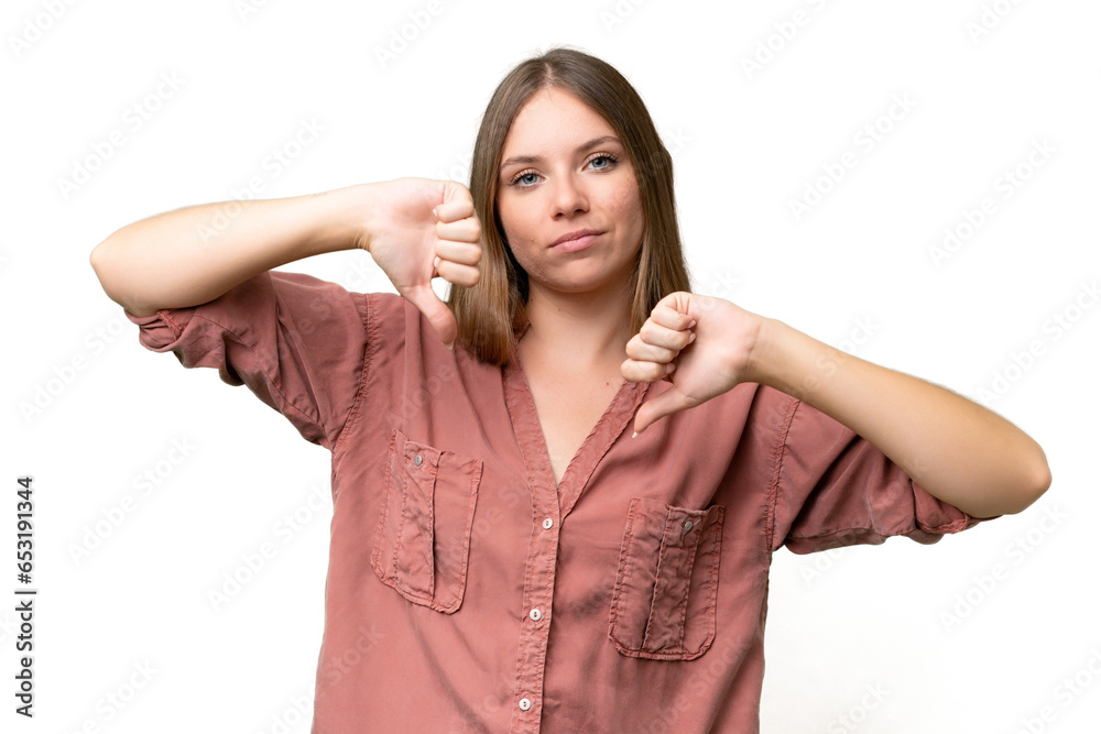 Young beautiful blonde woman over isolated background showing thumb down with two hands
