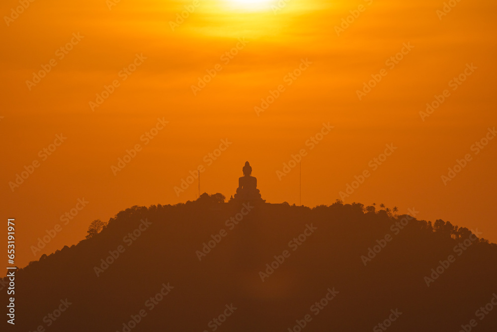 scenery yellow sky glare of sun above Phuket big Buddha.Phuket Big Buddha is one of the island most important and revered landmarks on the island..image for travel and culture concept.