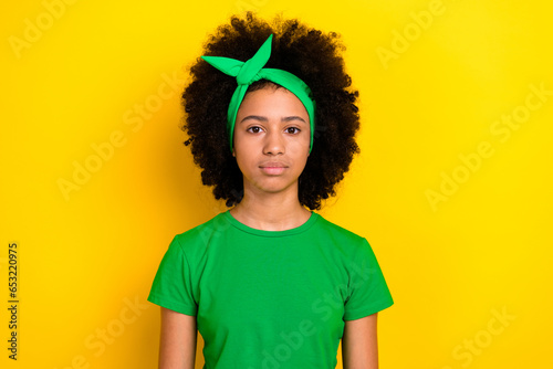 Photo of adorable pretty girl dressed green t-shirt hairband smiling isolated yellow color background