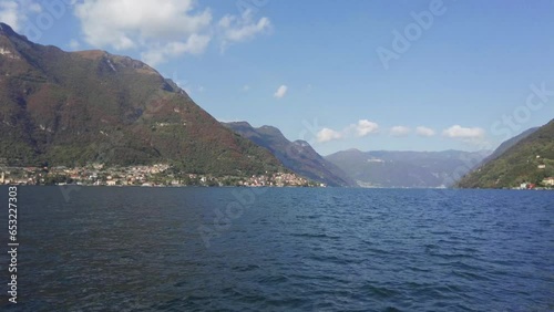 Pan right view from ferryboat, from Laglio town to another side of Lake Como, Pognana Lario village. photo