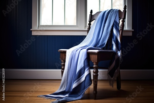 blue tallit prayer shawl draped over a chair photo