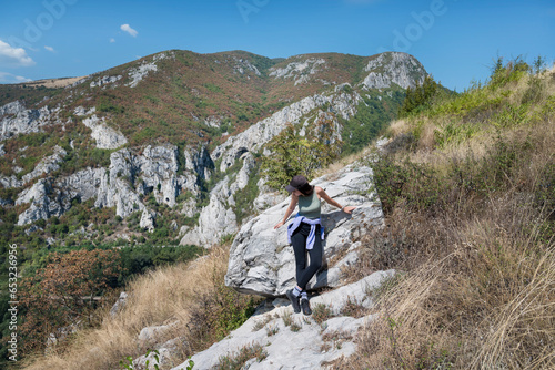 Woman standing in the  summer mountain with stunning view  © boryanam