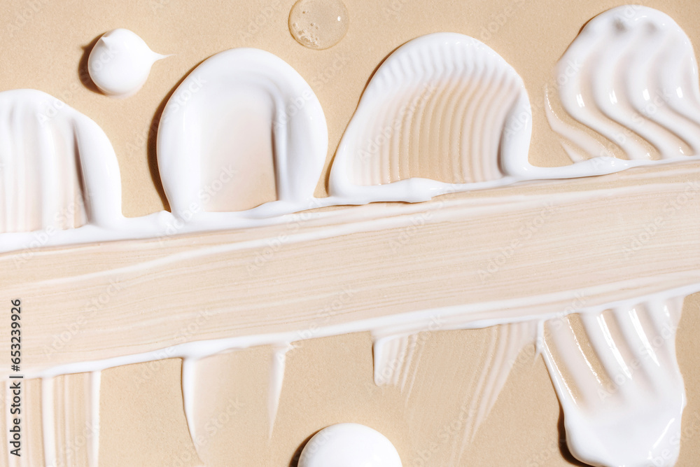 Fototapeta premium cosmetic smears of creamy texture on a beige background