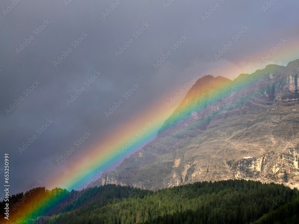 rainbow on monte croce cross mountain in dolomites badia valley panorama landscape
