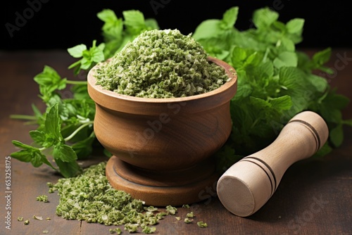 a wooden mortar with crushed oregano, surrounded by sprigs of fresh oregano