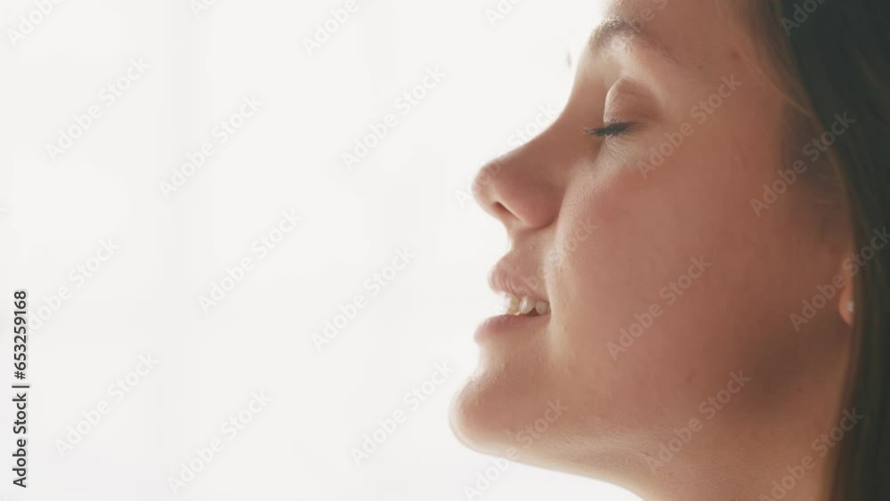 girl on a white background looks to the side. beauty dream concept. woman closes her eyes she dreams. the girl lifestyle smiles, shows her teeth, she thinks about her wonderful future girl on a white background looks to the side. beauty dream concept. woman closes her eyes she dreams. the girl lifestyle smiles, shows her teeth, she thinks about her wonderful future
