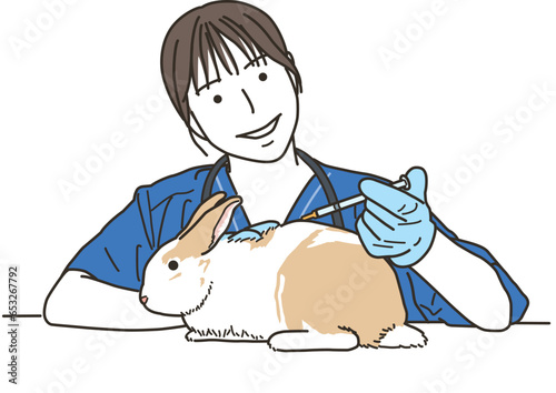 兎（小動物）に注射をする女性の獣医
