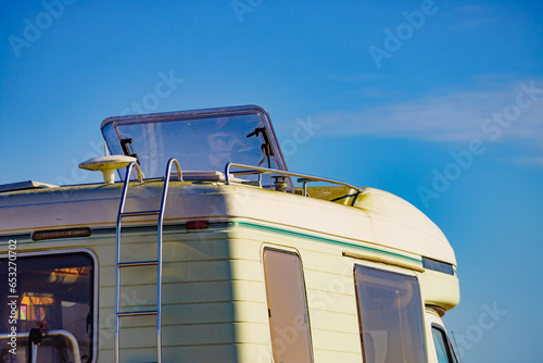 Caravan with open sunroof, raisable window on roof top photo