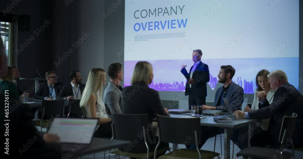 Corporate Event: Caucasian Male Tech CEO Giving Presentation To Colleagues, Investors In Conference Room Of Innovative Startup Company Office. Successful Man Talking About Business Vision And Mission.