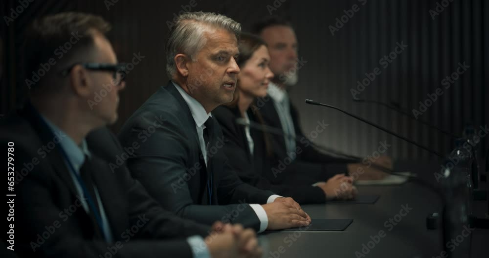 Zoom Out Shot: Caucasian Male Head Of Political Delegation Speaking At International Economic Forum Press Conference. High-Profile Politician Reporting On Successful Deals. Diverse Delegates Listening