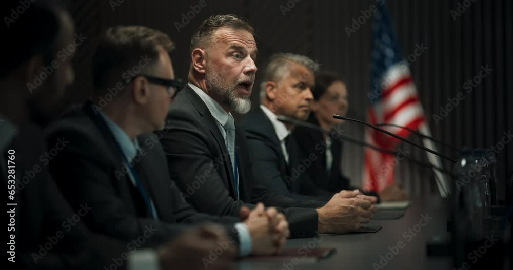 Caucasian Male Organization Representative Speaking at Economic Forum. Head Of USA Delegation Delivering Speech at International Political Summit Press Conference. Diverse Delegates Listening.